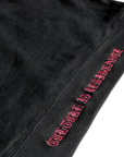 Close-up of Culture is Resistance red high-density direct embroidery on garment ribbing