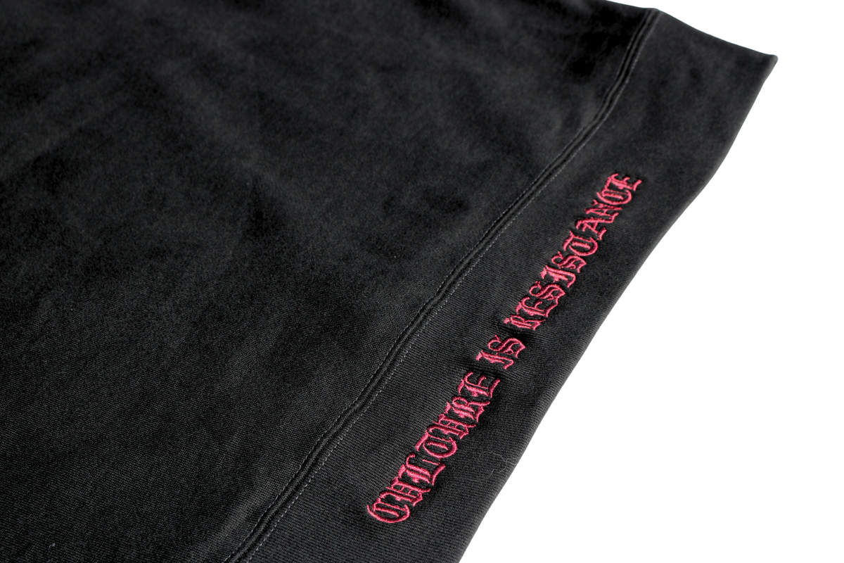 Close-up of Culture is Resistance red high-density direct embroidery on garment ribbing