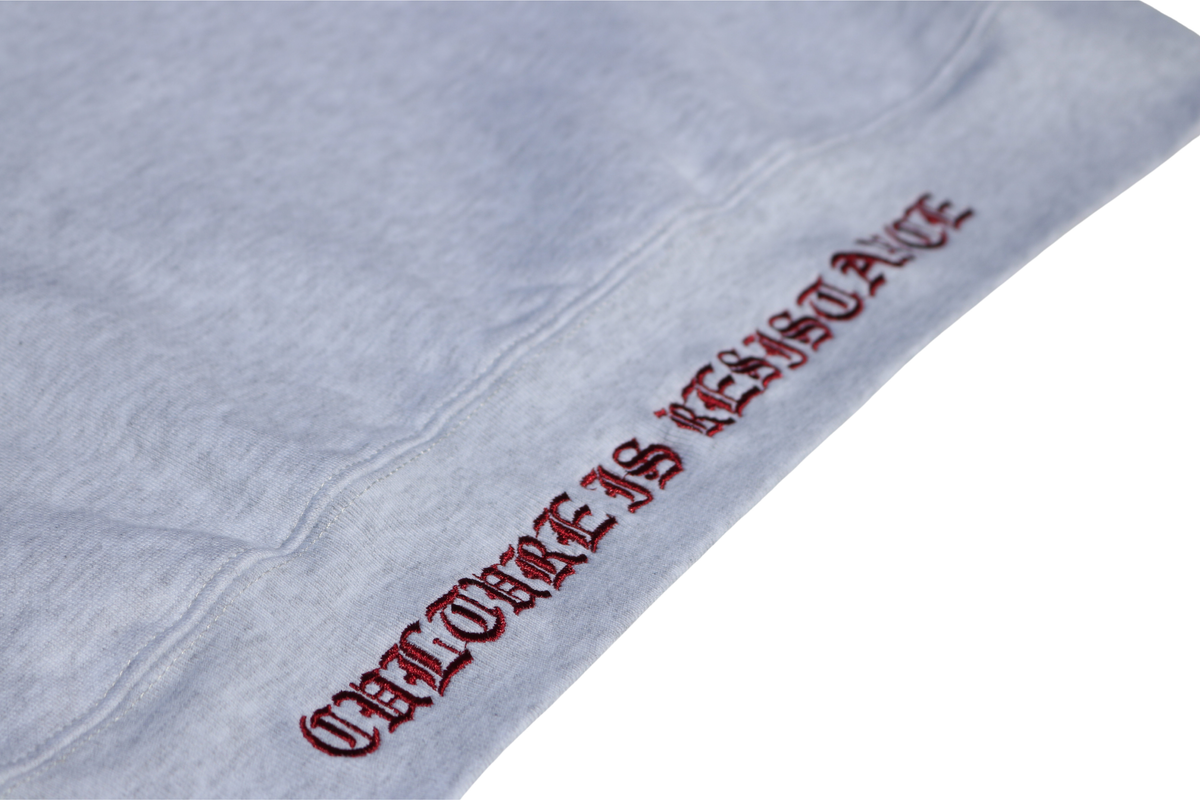 Close-up of Culture is Resistance red high-density direct embroidery on garment ribbing