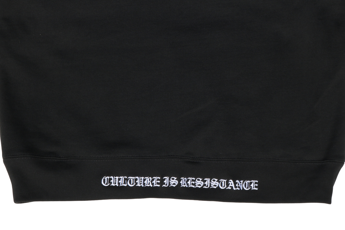 Close-up of Culture is Resistance red high-density direct embroidery on garment ribbing