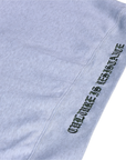 Close-up of Culture is Resistance red high-density direct embroidery on garment ribbing